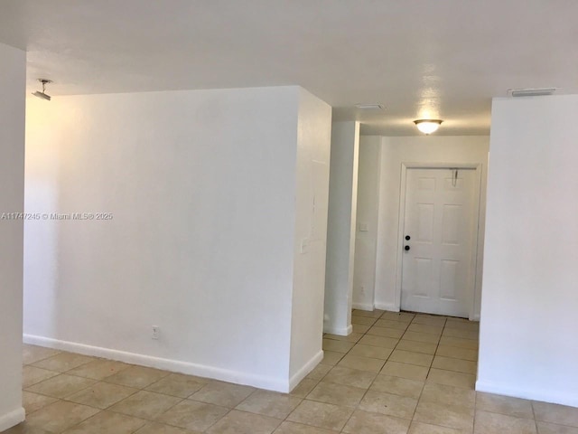 hallway featuring light tile patterned floors