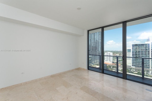 68 SE 6th St Unit 2112, Miami, FL 33131 - unfurnished room with a wall of windows