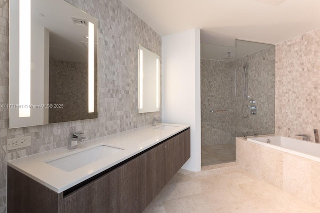 68 SE 6th St Unit 2112, Miami, FL 33131 - bathroom featuring separate shower and tub, decorative backsplash, tile walls, and tile patterned flooring