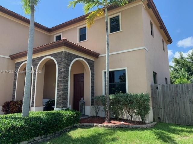 mediterranean / spanish home with a front yard