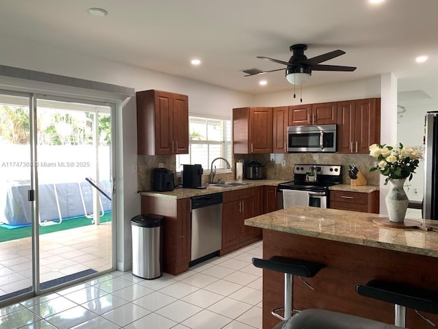 862 NW 132nd Ct, Miami, FL 33182 - kitchen featuring light tile patterned flooring, a sink, a kitchen breakfast bar, appliances with stainless steel finishes, and ceiling fan