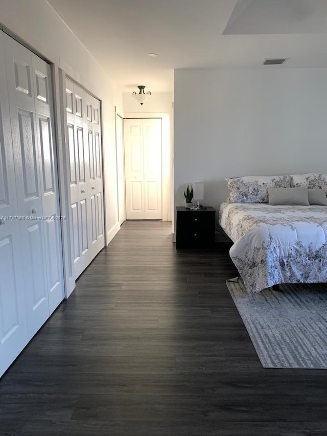 862 NW 132nd Ct, Miami, FL 33182 - unfurnished bedroom with dark wood-style floors, multiple closets, and visible vents