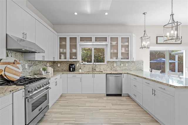 kitchen featuring appliances with stainless steel finishes, sink, white cabinetry, and backsplash