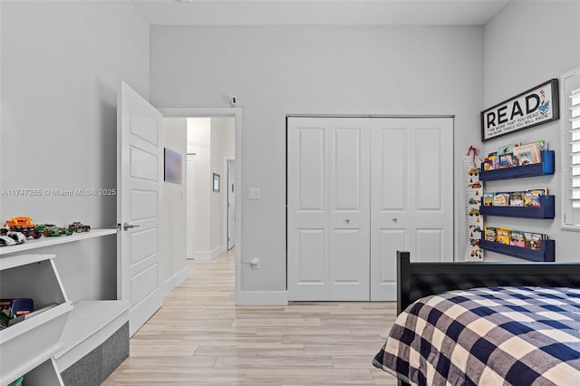 bedroom featuring light hardwood / wood-style flooring and a closet