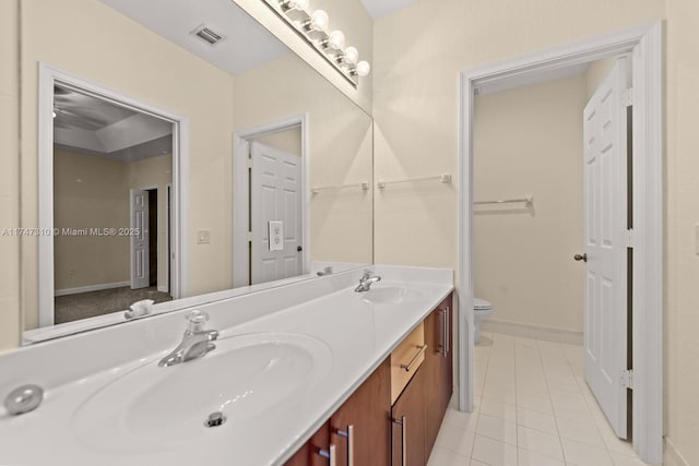 bathroom featuring tile patterned flooring, vanity, and toilet