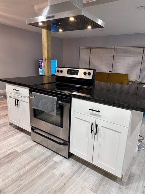 kitchen featuring stainless steel range with electric stovetop, island range hood, light hardwood / wood-style floors, and white cabinets