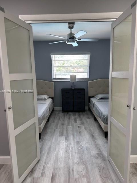 unfurnished bedroom featuring ceiling fan, a closet, and wood-type flooring