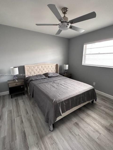 bedroom with ceiling fan and light hardwood / wood-style flooring