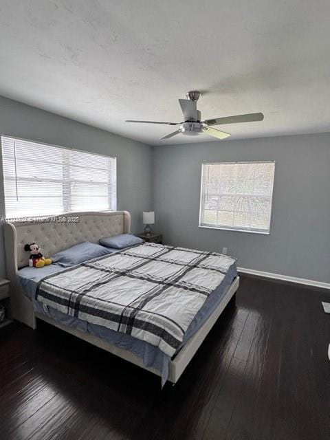 bedroom with ceiling fan and dark hardwood / wood-style flooring