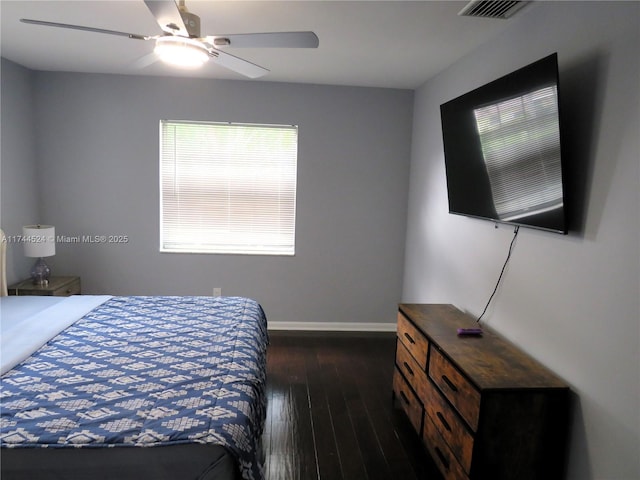 bedroom with dark hardwood / wood-style floors and ceiling fan