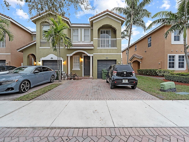 view of front facade featuring a garage and a balcony