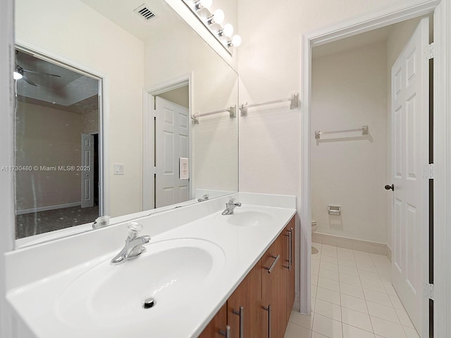 bathroom featuring vanity, tile patterned flooring, and toilet