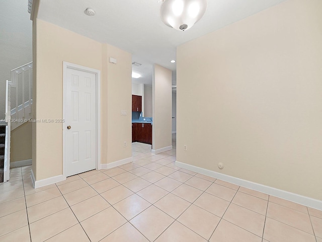 unfurnished room with light tile patterned floors