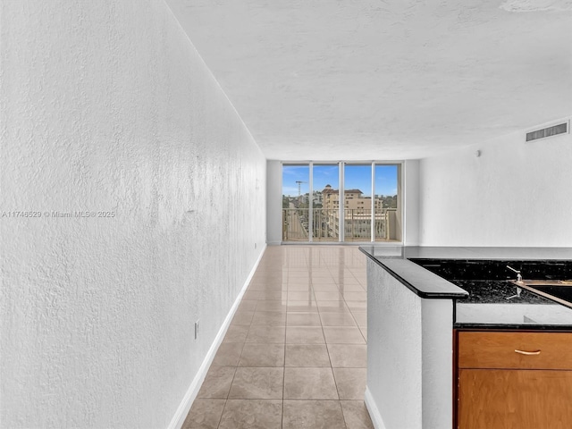 kitchen with light tile patterned flooring and floor to ceiling windows