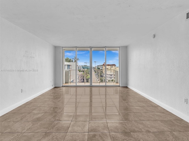 tiled empty room with a wall of windows