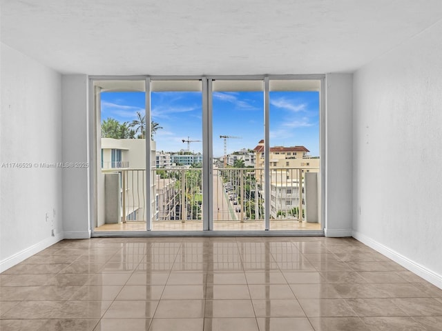 tiled spare room with expansive windows