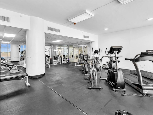 gym with a paneled ceiling