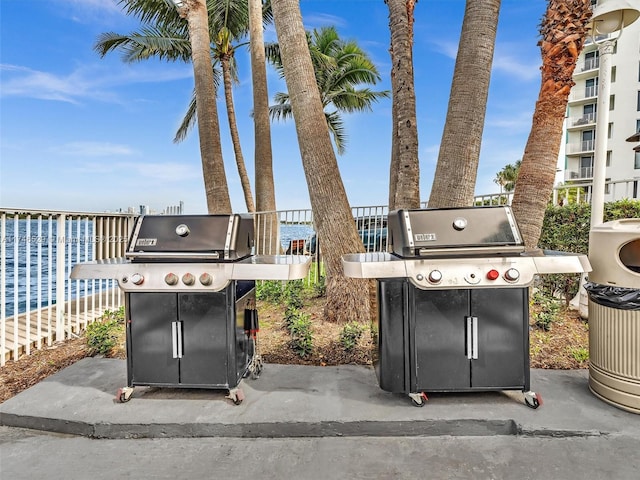 view of patio featuring a water view, area for grilling, and a balcony