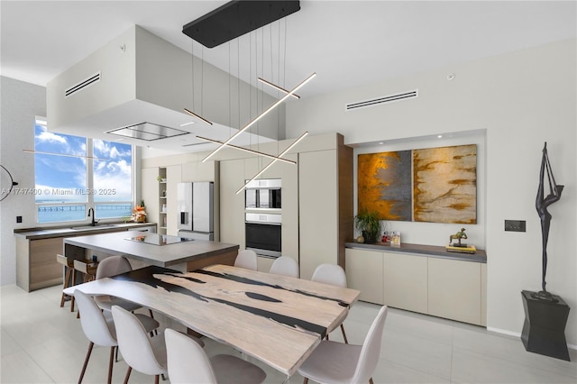 dining space with sink and light tile patterned floors