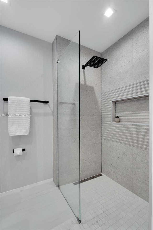 bathroom with a tile shower