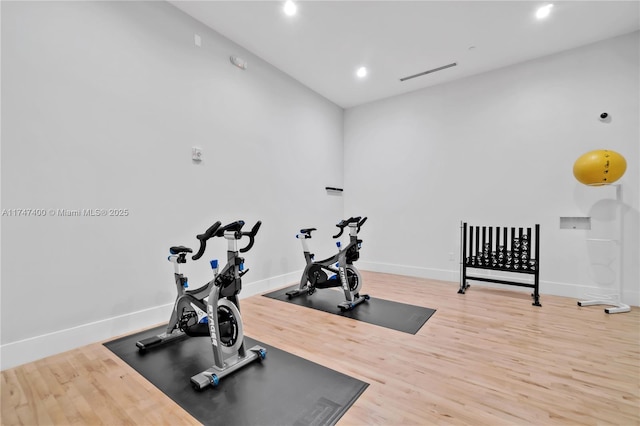 workout room with hardwood / wood-style floors