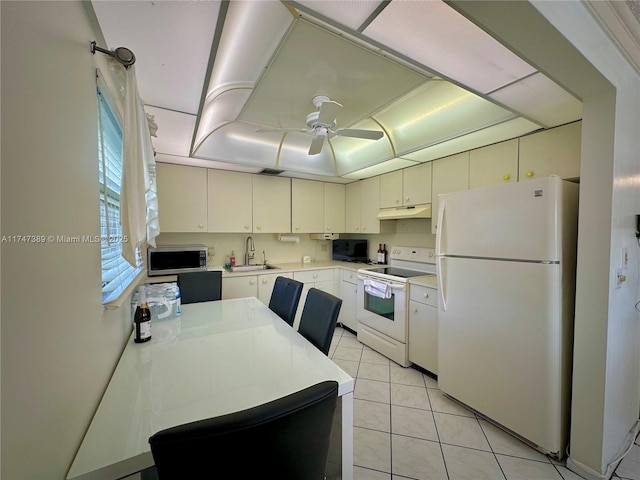 kitchen featuring light tile patterned flooring, under cabinet range hood, white appliances, white cabinetry, and light countertops