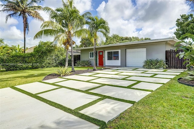 view of front of house featuring a front yard and a garage