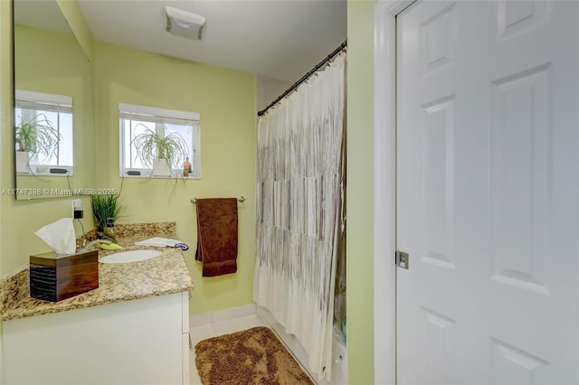 bathroom with tile patterned floors, vanity, and a shower with curtain