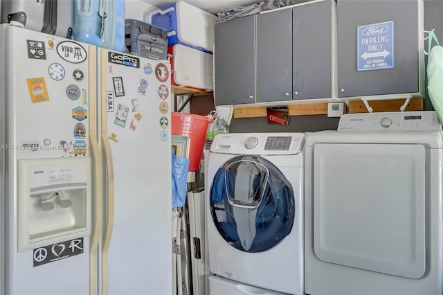 laundry room featuring independent washer and dryer and cabinets