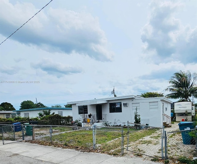 manufactured / mobile home featuring a fenced front yard and a gate