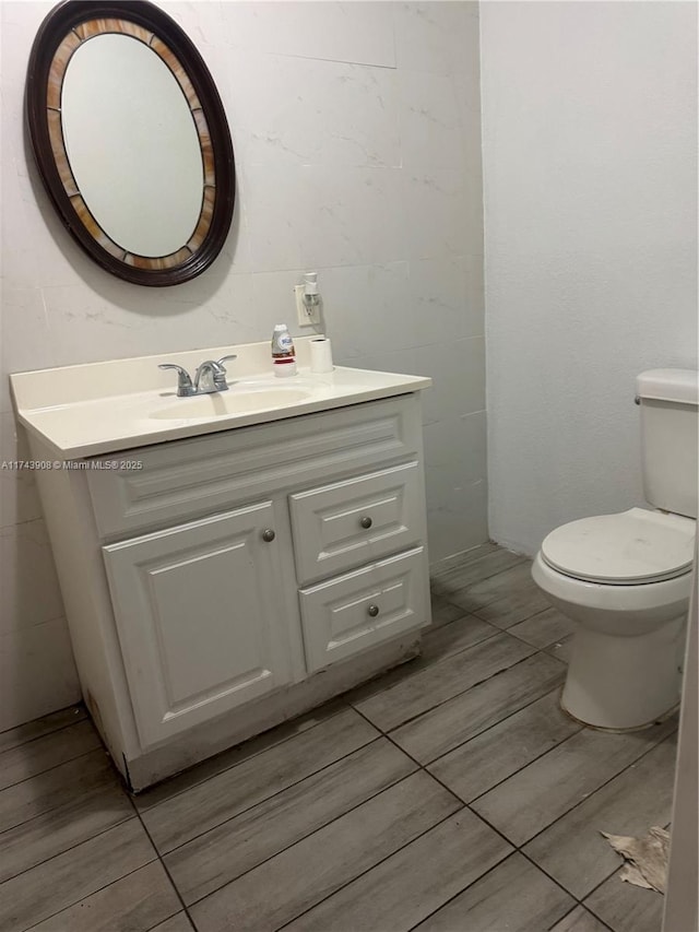 half bath with vanity and toilet