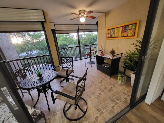 sunroom / solarium featuring ceiling fan