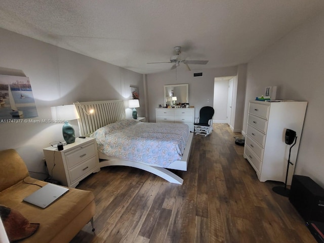 bedroom with dark hardwood / wood-style flooring, ceiling fan, and a textured ceiling