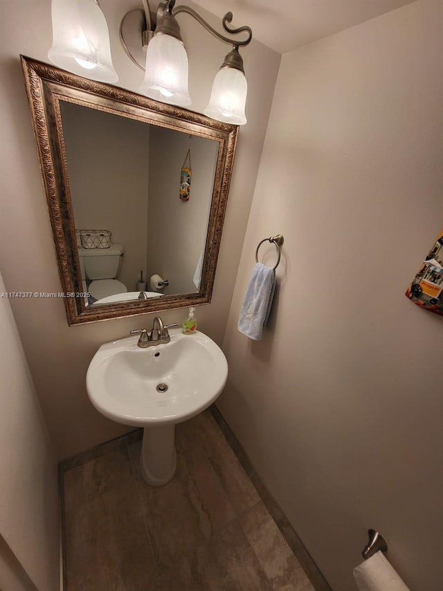 bathroom featuring sink and toilet