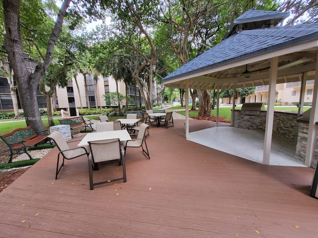 wooden terrace featuring area for grilling, a grill, and a gazebo