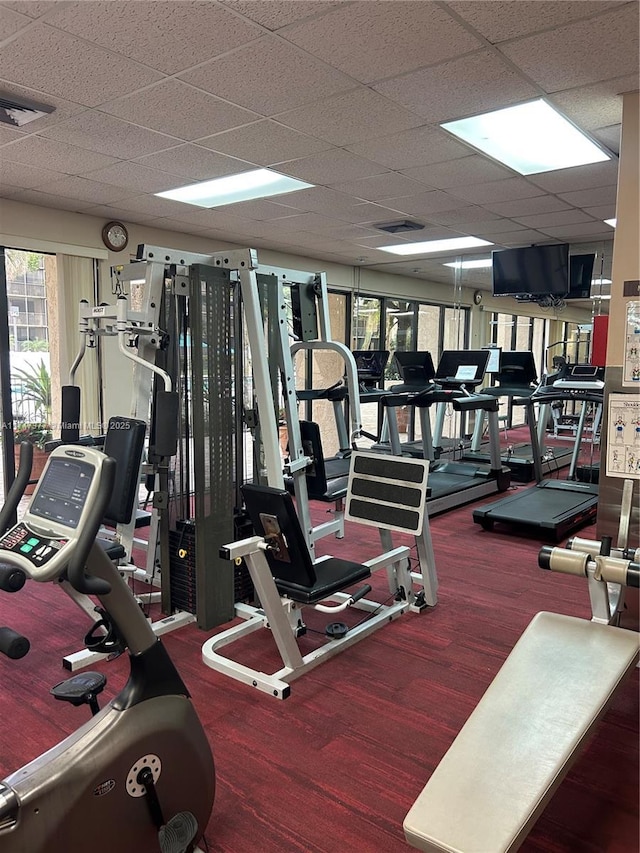 gym featuring a paneled ceiling