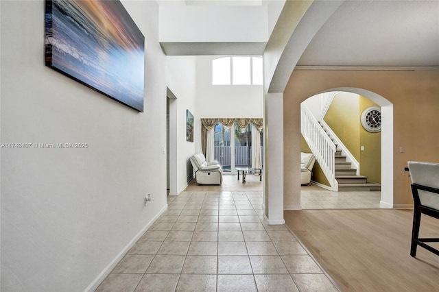 1588 SW 191st Ave, Pembroke Pines, FL 33029 - hallway with arched walkways, tile patterned floors, stairway, and baseboards