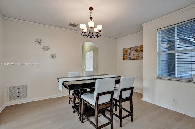 1588 SW 191st Ave, Pembroke Pines, FL 33029 - dining space with arched walkways, visible vents, light wood-type flooring, and an inviting chandelier