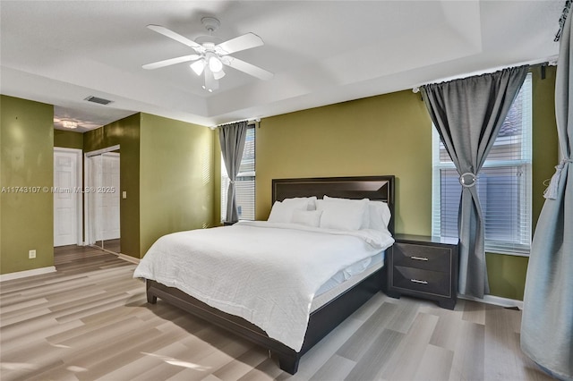 1588 SW 191st Ave, Pembroke Pines, FL 33029 - bedroom featuring a tray ceiling, a ceiling fan, visible vents, wood finished floors, and baseboards
