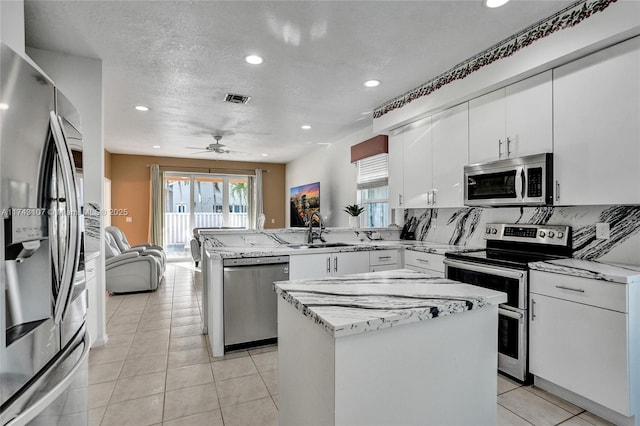 1588 SW 191st Ave, Pembroke Pines, FL 33029 - kitchen featuring recessed lighting, a peninsula, a sink, and appliances with stainless steel finishes