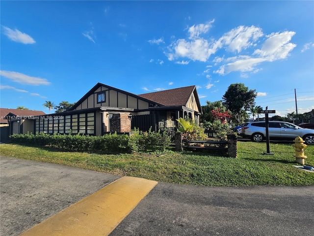 view of side of property with a yard