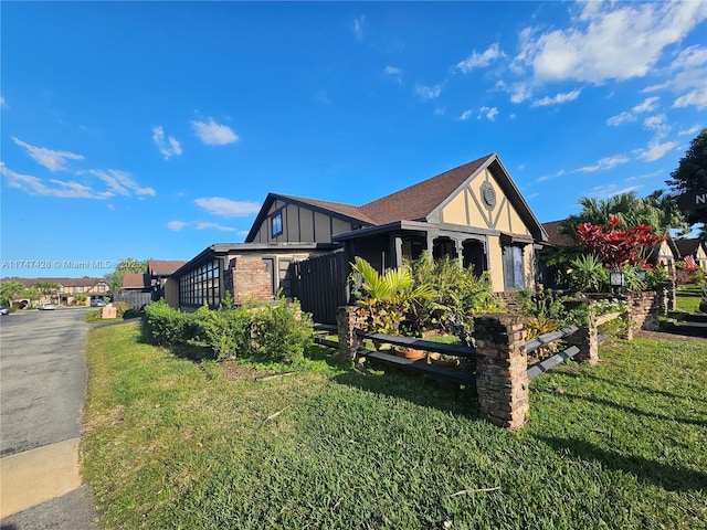 view of side of property featuring a lawn