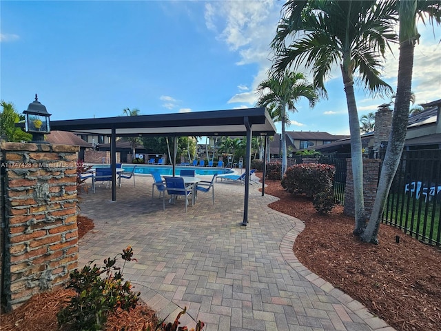 view of patio featuring a gazebo and a community pool