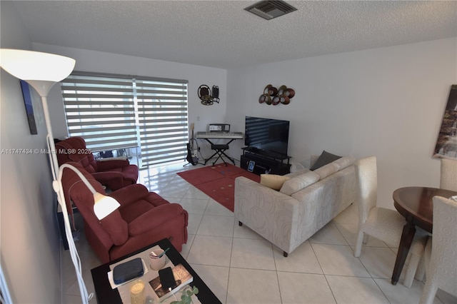 living room featuring light tile patterned floors and a textured ceiling