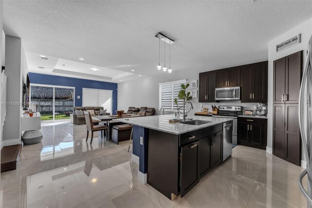 15124 SW 176th Ter, Miami, FL 33187 - kitchen with a sink, stainless steel appliances, open floor plan, a textured ceiling, and decorative light fixtures