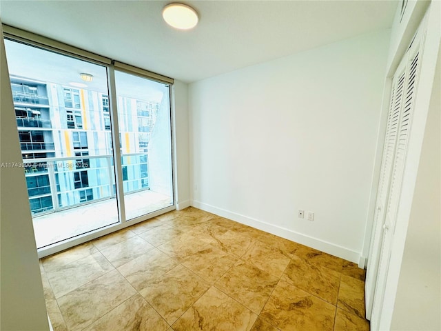 unfurnished room with expansive windows