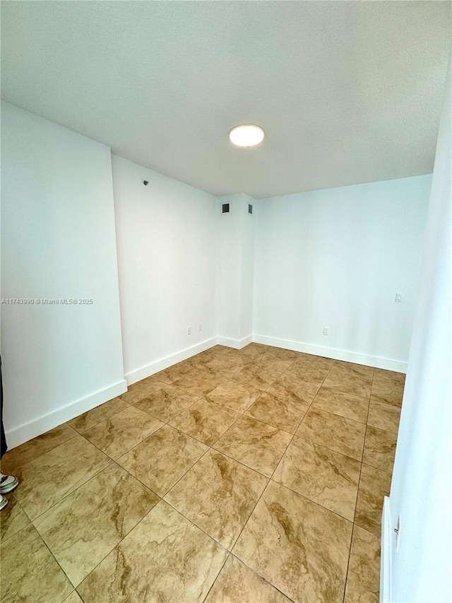 spare room featuring tile patterned floors