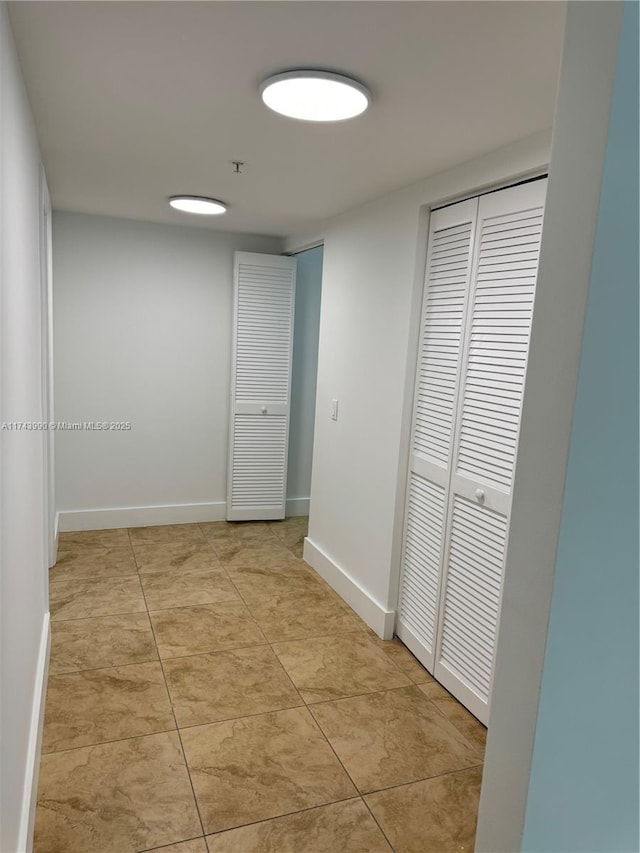 hall featuring light tile patterned flooring