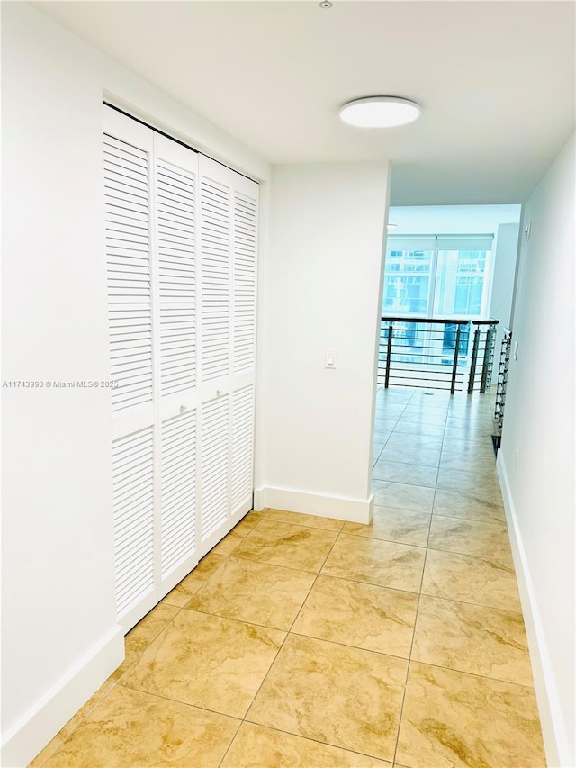 corridor featuring light tile patterned floors