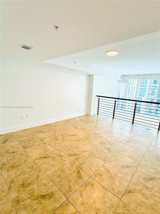 empty room featuring light tile patterned floors